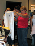 Someone looking at a t-shirt at the Lendon F. Grey bookstore